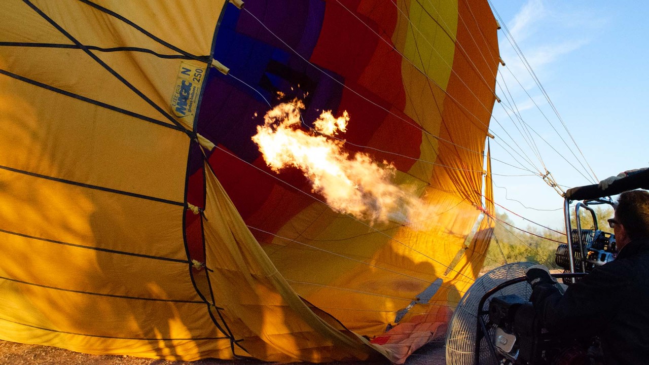 Hot air lifts the balloon off the ground.