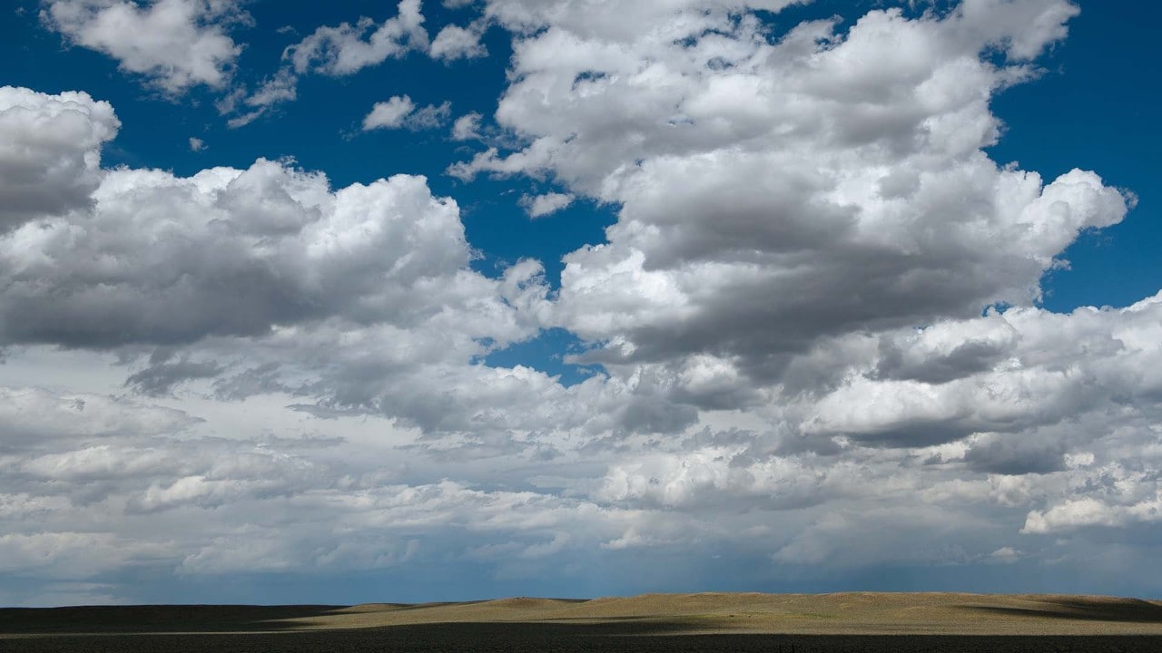 Rolling hills and billowing clouds are a common sight along Interstate 80 in southern Wyoming.
