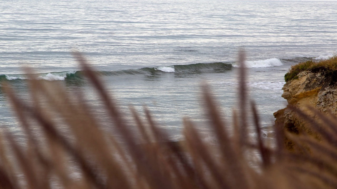 Waves roll into the California coast.