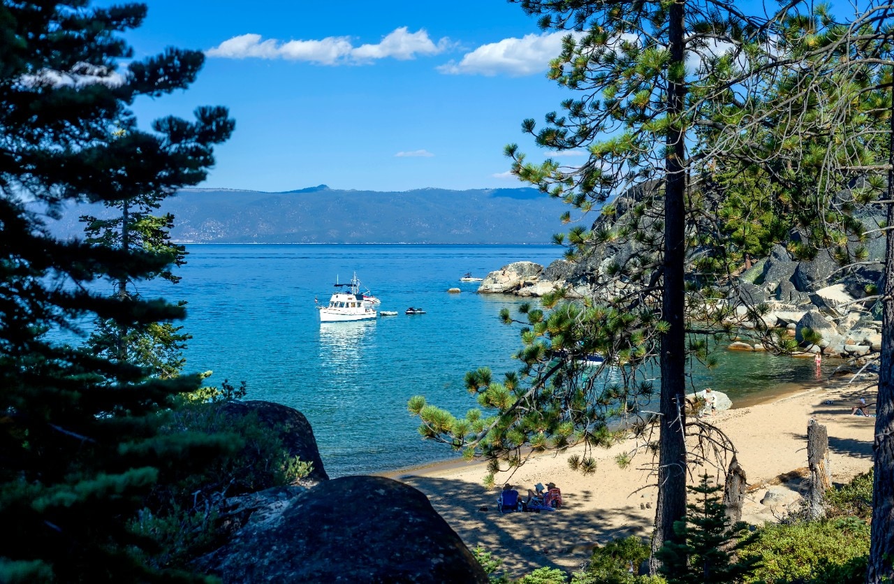 D.L. Bliss State Park, SOUTH LAKE TAHOE, CA "u2013 December 29, 2015: An image of D.L. Bliss State park cove where recreational boats and paddle boarders can take advantage of secluded coves and sunny beaches. Image feature boats moored in the cove and people resting on the beach.